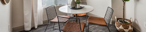 a dining room with a table and chairs and a ceiling fan at Mirasol Apartments, Nevada