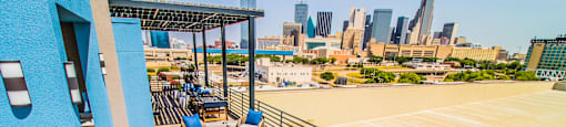 a rooftop patio with tables and chairs and a view of the city at South Side Flats, Dallas, TX