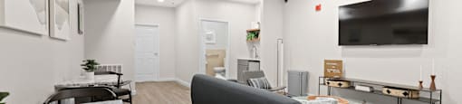 a living room with a couch and a tv  at Switchback on Platte Apartments, Littleton, Colorado
