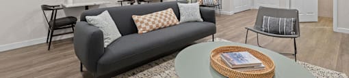 a living room with a couch and a table at Switchback on Platte Apartments, Littleton, CO