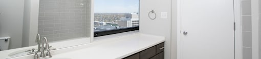 a bathroom with a sink and a window  at Apartments at Denver Place, Colorado