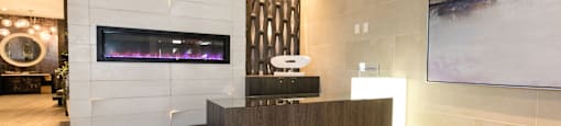the lobby of a hotel with a reception desk and a fireplace  at Apartments at Denver Place, Denver Colorado