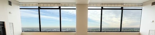 an empty living room with a window view of the city at Apartments at Denver Place, Denver, CO 80202