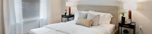 a white bedroom with a large bed and a window at Volare at the Woodlands, The Woodlands, 77384