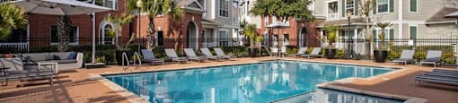 a large swimming pool in front of an apartment building  at Volare at the Woodlands, The Woodlands, Texas