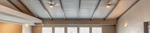 an empty room with windows and a carpeted floor at Willow Hill Apartments, Justice, IL