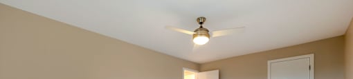 a spacious bedroom with carpet and a ceiling fan at Willow Hill Apartments, Justice, IL, 60458
