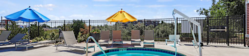 our resort style swimming pool is next to the patio and umbrellas at Ridge at Thornton Station Apartments, Thornton, 80229