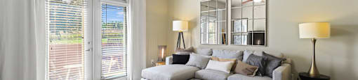 a living room with a couch and a ceiling fan at Apartments at Ridge at Thornton Station Apartments, Thornton, CO 80229