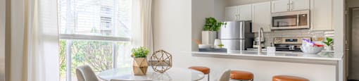 a kitchen and dining room with a table and chairs at Ashford Green, Charlotte, NC
