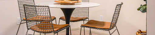a dining room with a table and chairs at Atria at Crabtree Valley, NC 27612