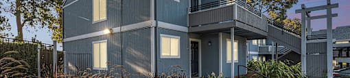 a blue house with a deck and a sunset at Bay Village, Vallejo, 94590