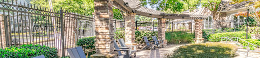 a patio with benches and a fence and trees at Deerfield Village, Alpharetta, GA, 30004
