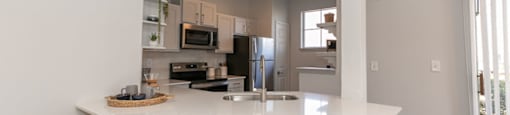 a kitchen with a large island and two stools at Deerfield Village, Alpharetta, Georgia