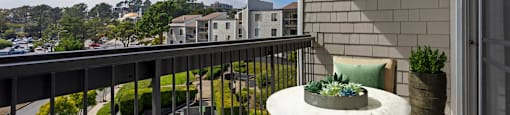 a balcony with a table and chairs and a city view at Delphine on Diamond, San Francisco, California