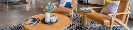a living room with a couch and chairs and a table at Highland Mill Lofts, Charlotte, North Carolina
