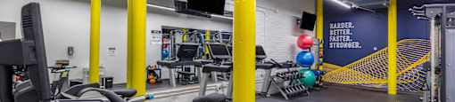 a gym with cardio equipment and weights in a building at Highland Mill Lofts, Charlotte