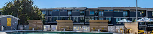 a swimming pool with a building in the background at Highland Mill Lofts, Charlotte, NC