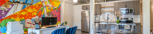a living room with a kitchen and a table and chairs at Highland Mill Lofts, Charlotte, 28205
