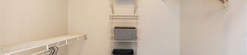 a walk in closet with racks and towels at Mirasol Apartments, Las Vegas