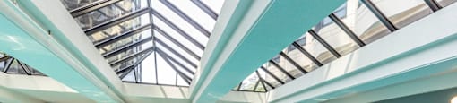 a swimming pool with a glass ceiling and chairs at North Harbor Tower, Chicago