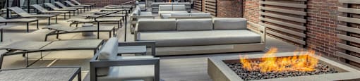 a lounge area with couches and tables and a fire pit at North Harbor Tower, Illinois