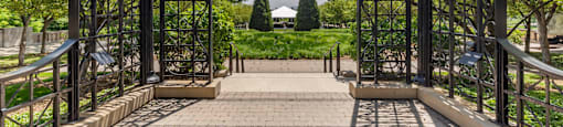 the entrance to a park with a metal structure and stairs at North Harbor Tower, Chicago