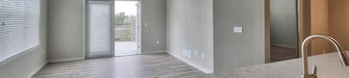an empty kitchen and living room with a ceiling fan at Ridge at Thornton Station Apartments, Thornton, CO