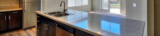a kitchen with a counter top and a sink at Ridge at Thornton Station Apartments, Thornton, 80229