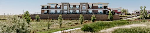 a path leading to a building in a field at Ridge at Thornton Station Apartments, Colorado
