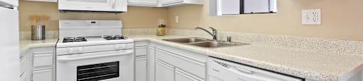 Kitchen with dishwasher at River Oaks in Oceanside, CA