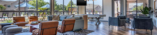 a living room with couches and chairs and a table at Sladestone Shadow Creek, Texas