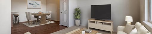 a living room with a couch and a television at Switchback on Platte Apartments, Littleton, Colorado