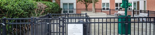 a sign on a fence in front of an apartment building at Amelia, Quincy, MA, 02169