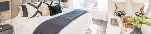 a bedroom with a bed and a large window at The Elle Apartments, Chicago, IL