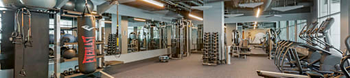 a gym with weights and other exercise equipment in a building  at Vue, San Pedro, CA