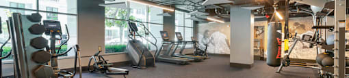 a gym with cardio equipment and windows in a building  at Vue, San Pedro, CA, 90731