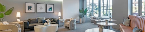 a large living room with couches and tables  at Vue, San Pedro, 90731