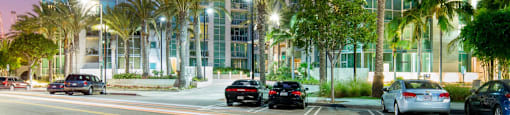 a view of a tall building at night with palm trees  at Vue, San Pedro, CA, 90731