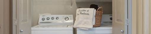 a small laundry room with a washer and dryer at Volare at the Woodlands, The Woodlands, TX, 77384