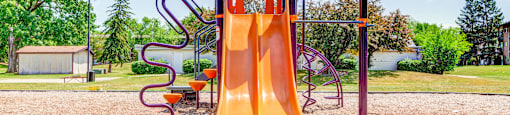 a slide on a playground at a park at Willow Hill Apartments, Justice, IL