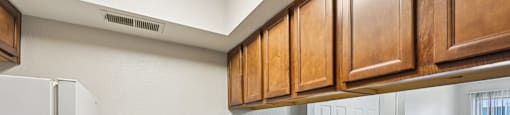 Kitchen with brown cabinetry at Sycamore Square Apartments, Mesa, AZ