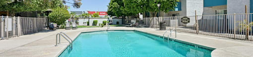 Swimming pool with metal railing at Sycamore Square Apartments, Mesa, Arizona