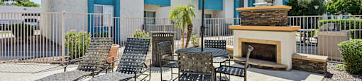 Outdoor patio with fireplace at Sycamore Square Apartments, Mesa