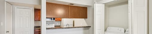 Kitchen with laundry room view at Sycamore Square Apartments, Mesa