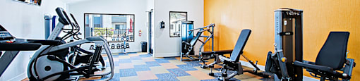 Gym with a treadmill, weights, and a fan at Aspire Thunderbird, Glendale, AZ, Arizona