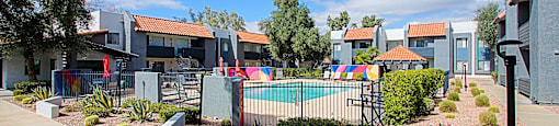 Swimming Pool surrounded by a small garden and a fence at Aspire Thunderbird, Glendale, AZ, 85304