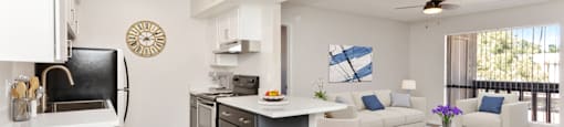 Equipped kitchen with a dining area and a living room at Aspire Thunderbird, Glendale, AZ