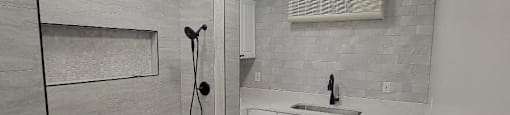 a white bathroom with a sink and a mirror