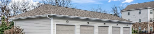 a garage with white doors and a roof